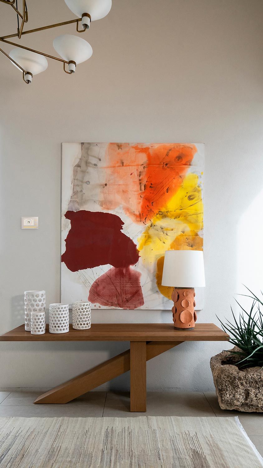 Crestron Home in a wall with a warm color abstract art piece