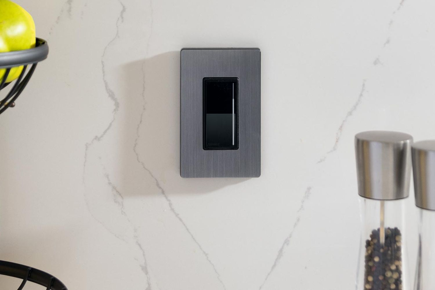 Lutron Lighting Control Keypad on a white marble kitchen wall